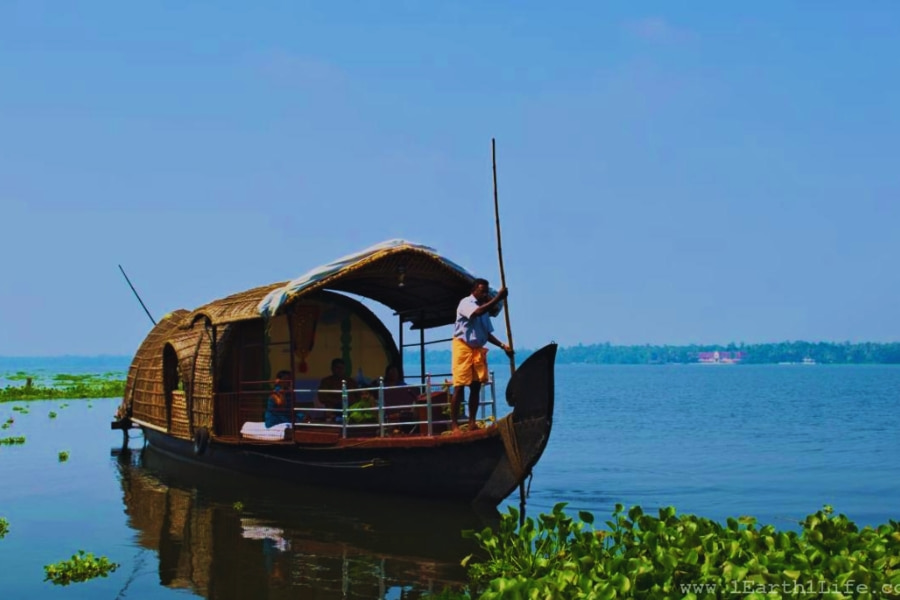 Traditional wooden boat on calm Mekong Delta waters for river cruises Auasia Travel